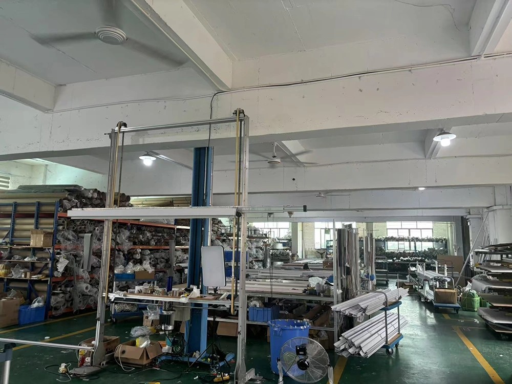 A specialized shade factory floor with zip-track components, fabric storage, and assembly stations.