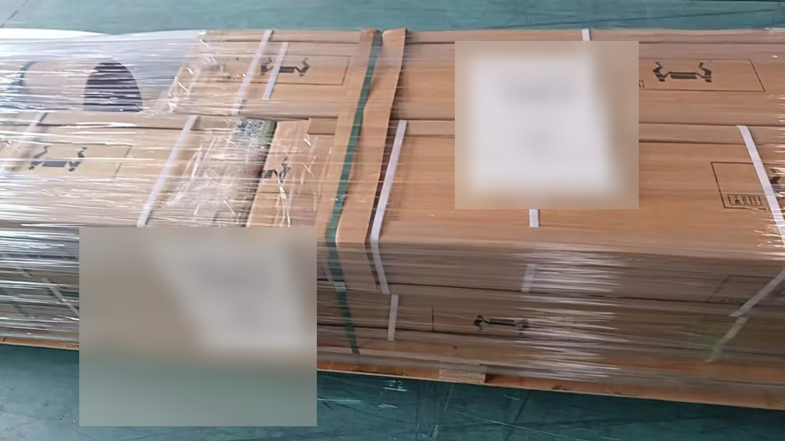 Custom screen cartons, wrapped and strapped to a wooden freight pallet.